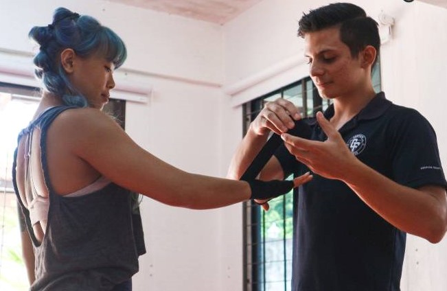 fierce fitness training in penang island, lady punching in muay thai personal training